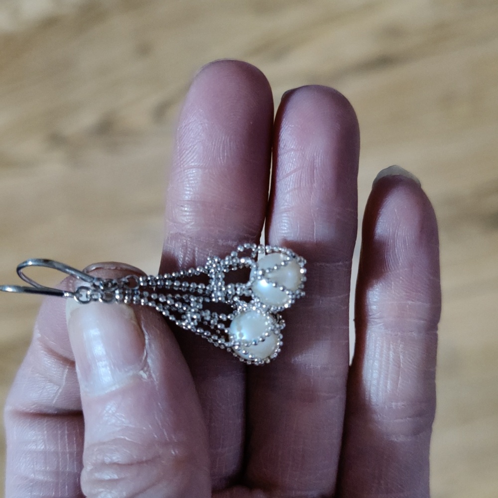 Sterling silver with a pearl in its sack
